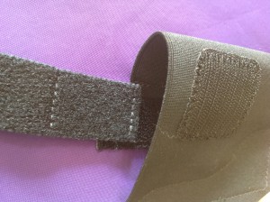 When you put the elastic strap in place, don't put it too deep into the pouch. It should be shallow enough that you can shove through it with your thumb while you're gripping the gun. 