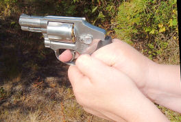 A thumbs locked down grip on a revolver